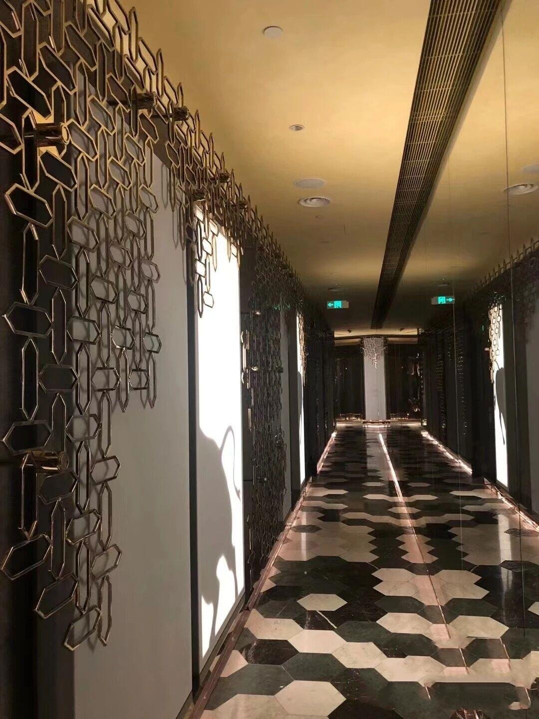 Modern corridor with artistic 3D geometric stainless steel wall cladding and integrated