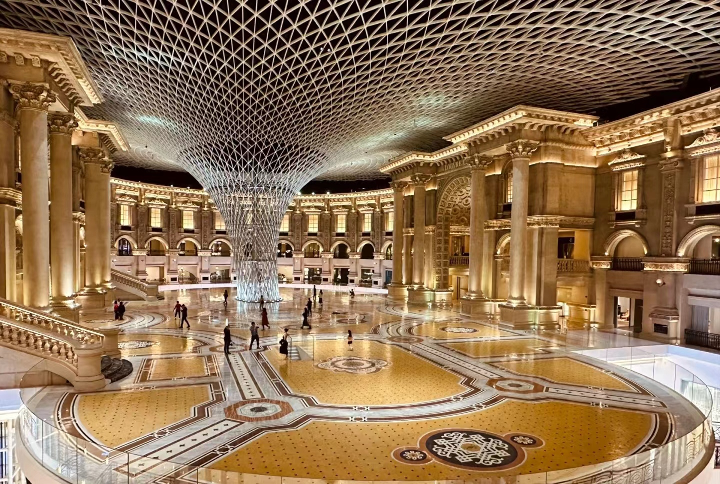 Metal Column Cladding featuring a large-scale sculptural lattice design for luxury plaza and public infrastructure interiors