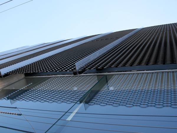 Durable aluminum expanded metal mesh panels used for exterior building sunshades and passive ventilation to improve energy efficiency.