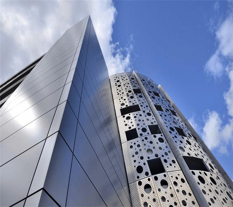 High-rise architectural aluminum cladding featuring a combination of solid rainscreen panels and custom perforated metal screens.
