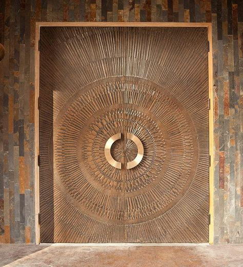 Grand entrance doors showcasing the intricate patterns possible with custom bonded metal sheets.