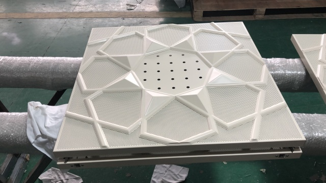 Architectural Metal Ceiling Systems featuring bespoke geometric perforated patterns for high-performance acoustic control