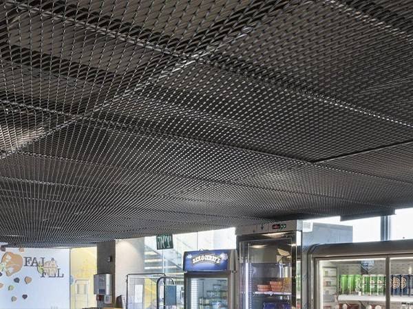 Decorative black powder-coated expanded metal mesh ceiling panels for industrial-style interior environments by XYC Metalworks