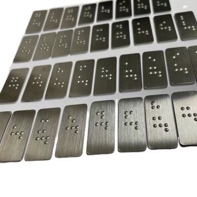 Batch of brushed stainless steel tactile Braille plates, designed to coordinate with Custom Fabricated Letters as part of our high-end Architectural Metal Signage and Stainless Steel & Brass Signs.