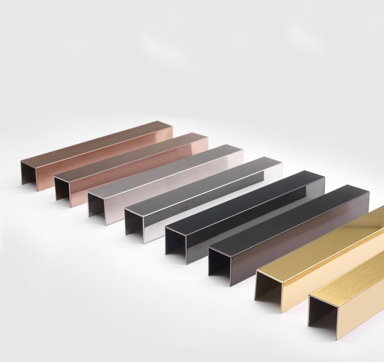 Various PVD coated stainless steel U-channel trims in gold, rose gold, and black for wall decoration.