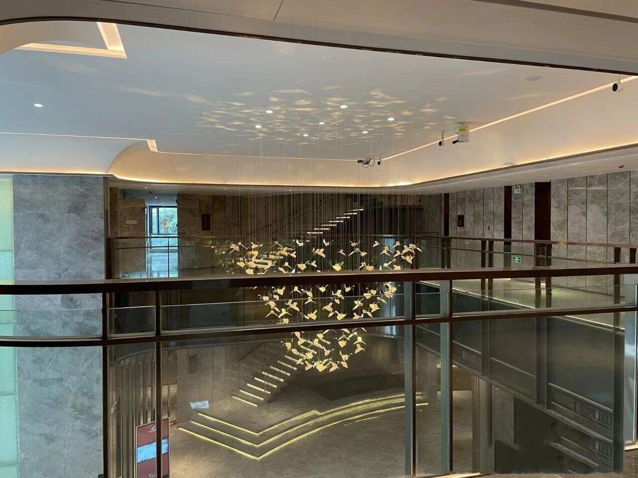 Modern glass panel railing system providing unobstructed views for a commercial office mezzanine or atrium.