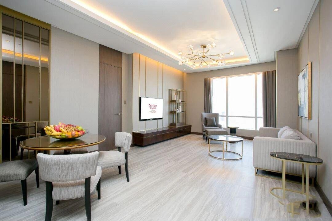 Luxury hotel suite featuring coordinated PVD gold Custom Stainless Steel Hotel Furniture, including display shelves and coffee tables, showcasing our premium PVD Hospitality Metalwork.