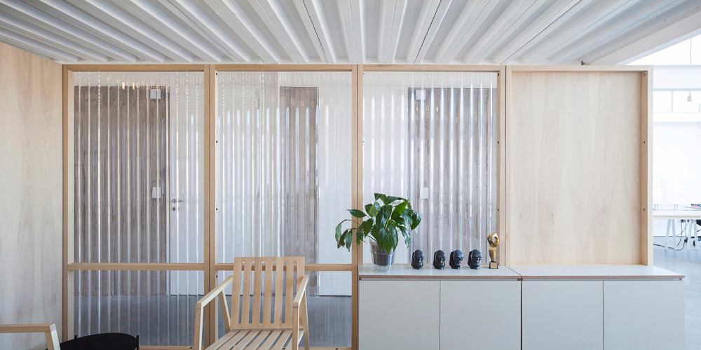 Contemporary office space using corrugated metal sheet for translucent partitions and modern room dividers