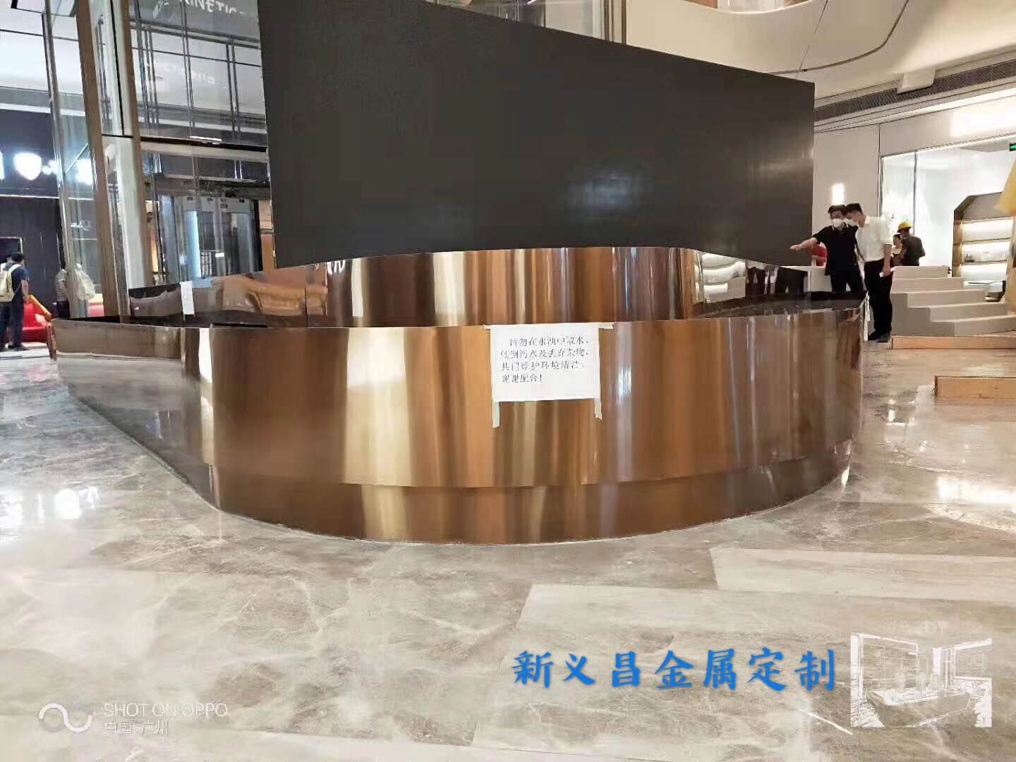 curved-bronze-reception-desk-cladding-louvre-pavilion