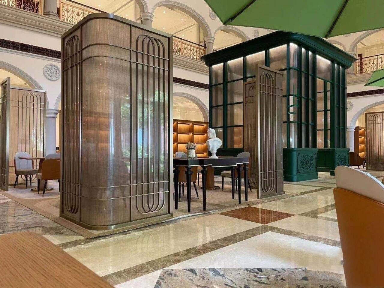 Architectural Metal Partitions using a curved fine mesh system to create elegant semi-private zones in a luxury hotel lounge