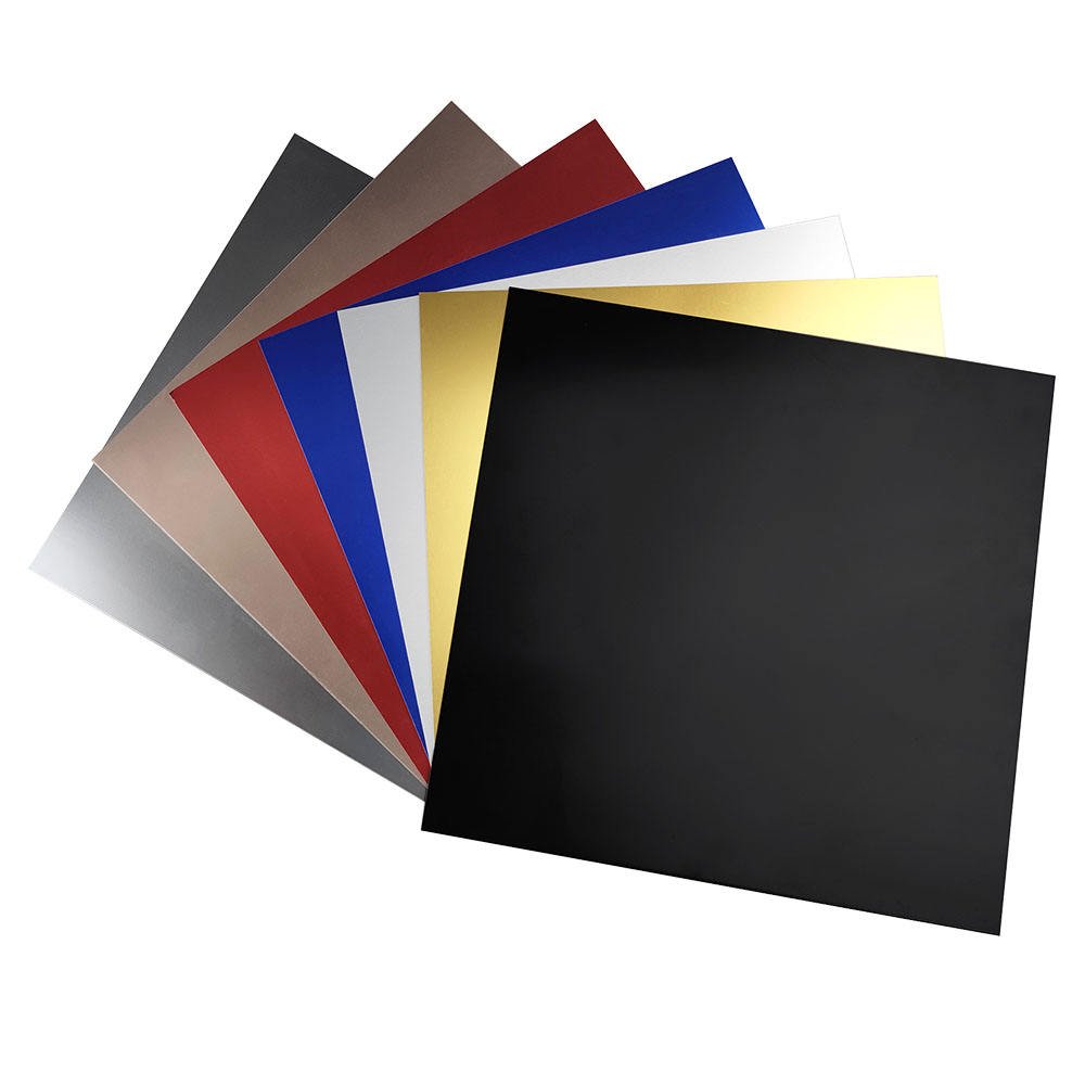 A fan of solid-color PVDF and powder-coated aluminum sheet samples for bespoke custom aluminum fabrication.