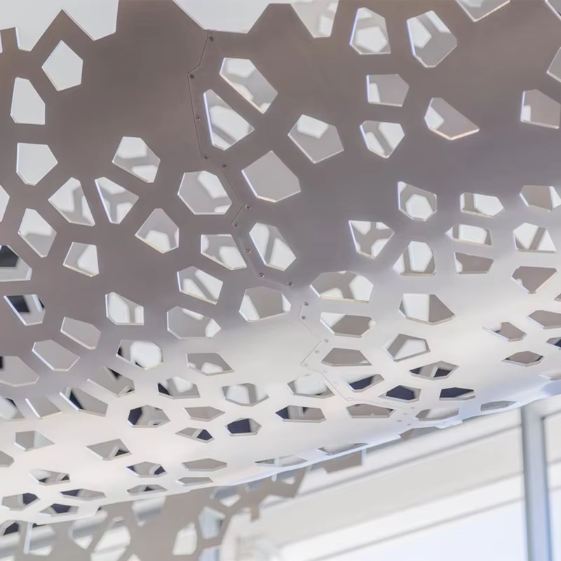 Bespoke perforated aluminum ceiling panel showing high-end custom aluminum fabrication by XYC Metalworks.