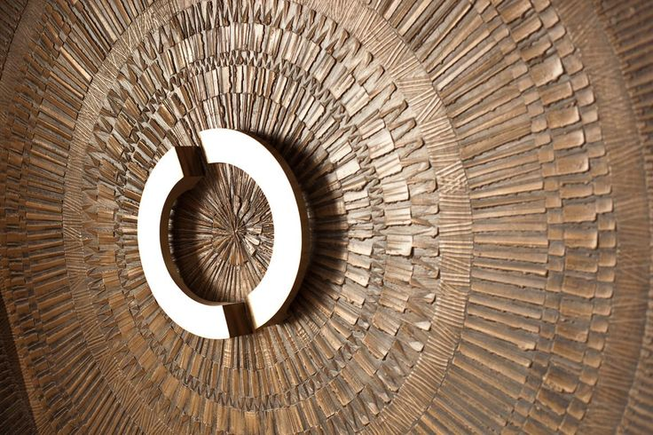 Close-up of a radial pattern door handle detail on a custom bonded metal sheets bronze entrance.