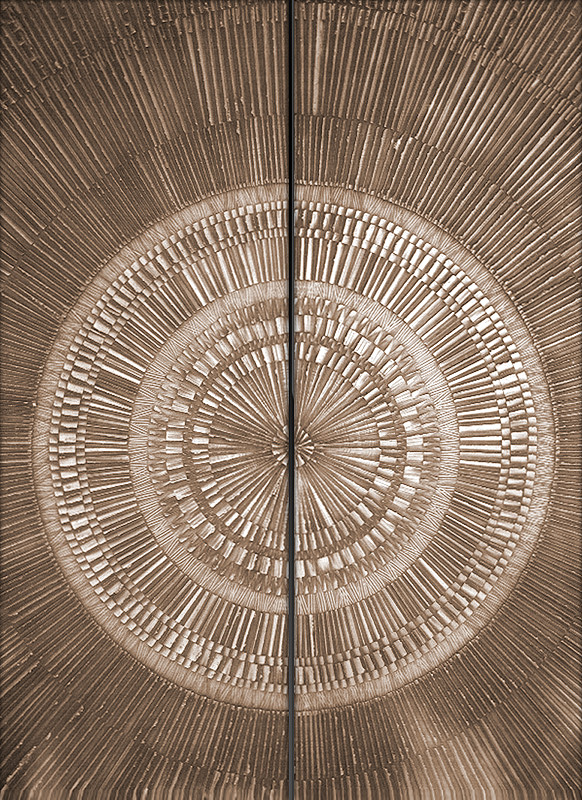 Luxury bronze entrance doors fabricated with intricate radial patterned custom bonded metal sheets.