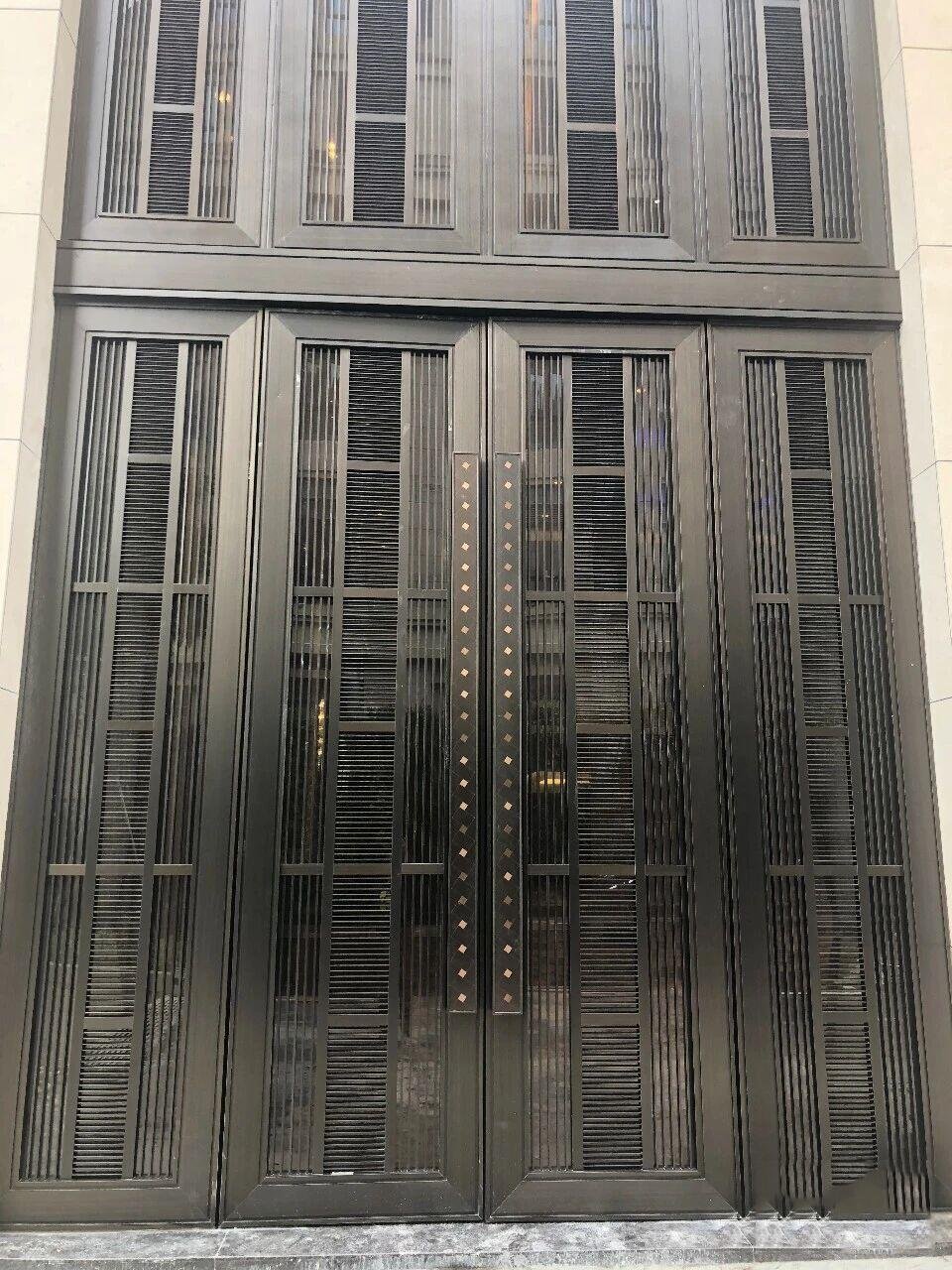 Stainless Steel Interior Doors featuring PVD bronze louvered panels and Custom Pull Handles with diamond inlays.