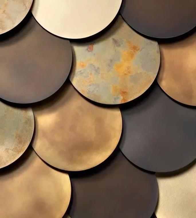 Detailed texture of custom patina metal scale tiles in various shades of aged bronze, antique brass, and oxidized copper.