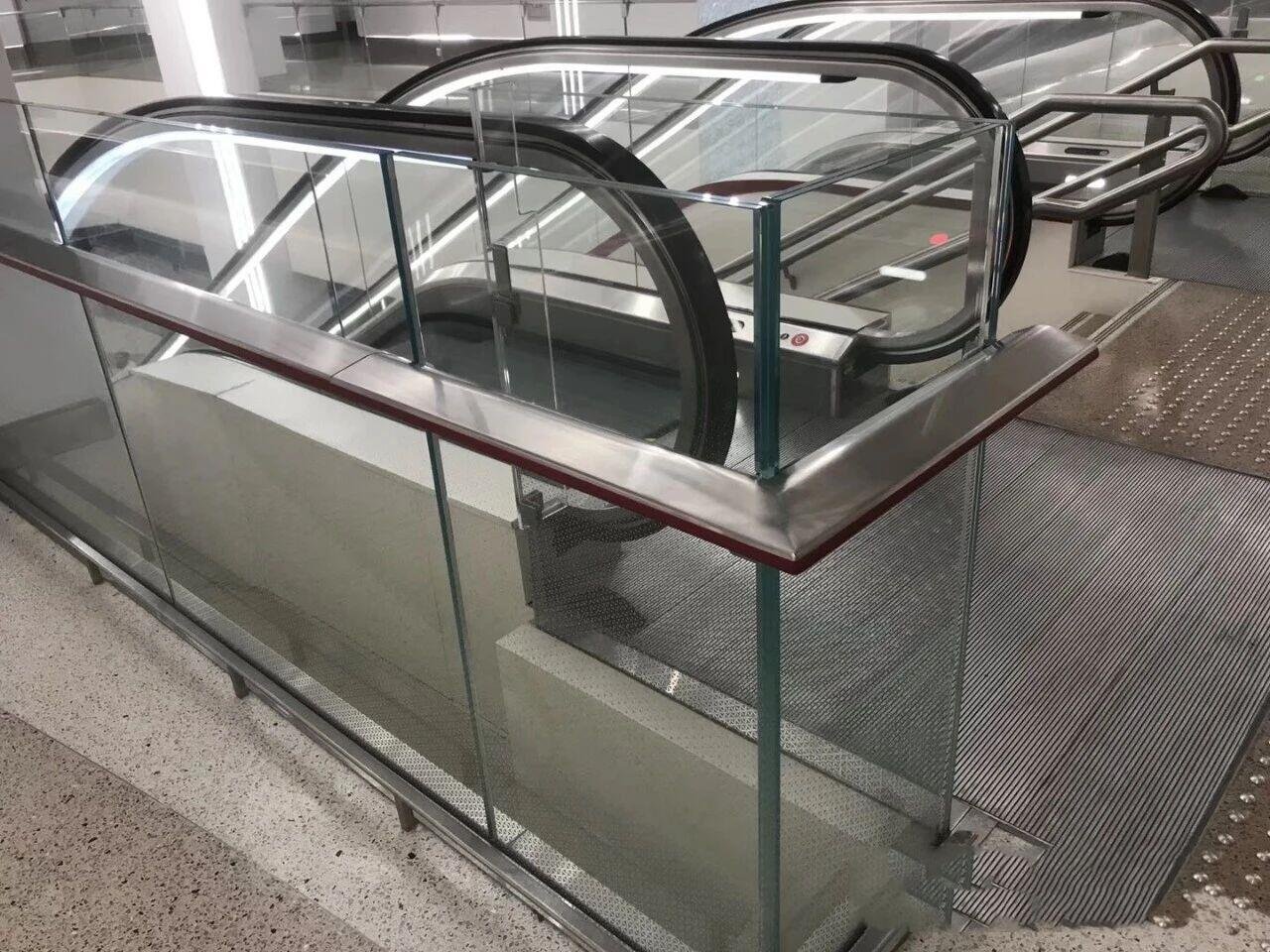 custom-profile-bronze-handrail-on-glass-balustrade-doha-metro-detail