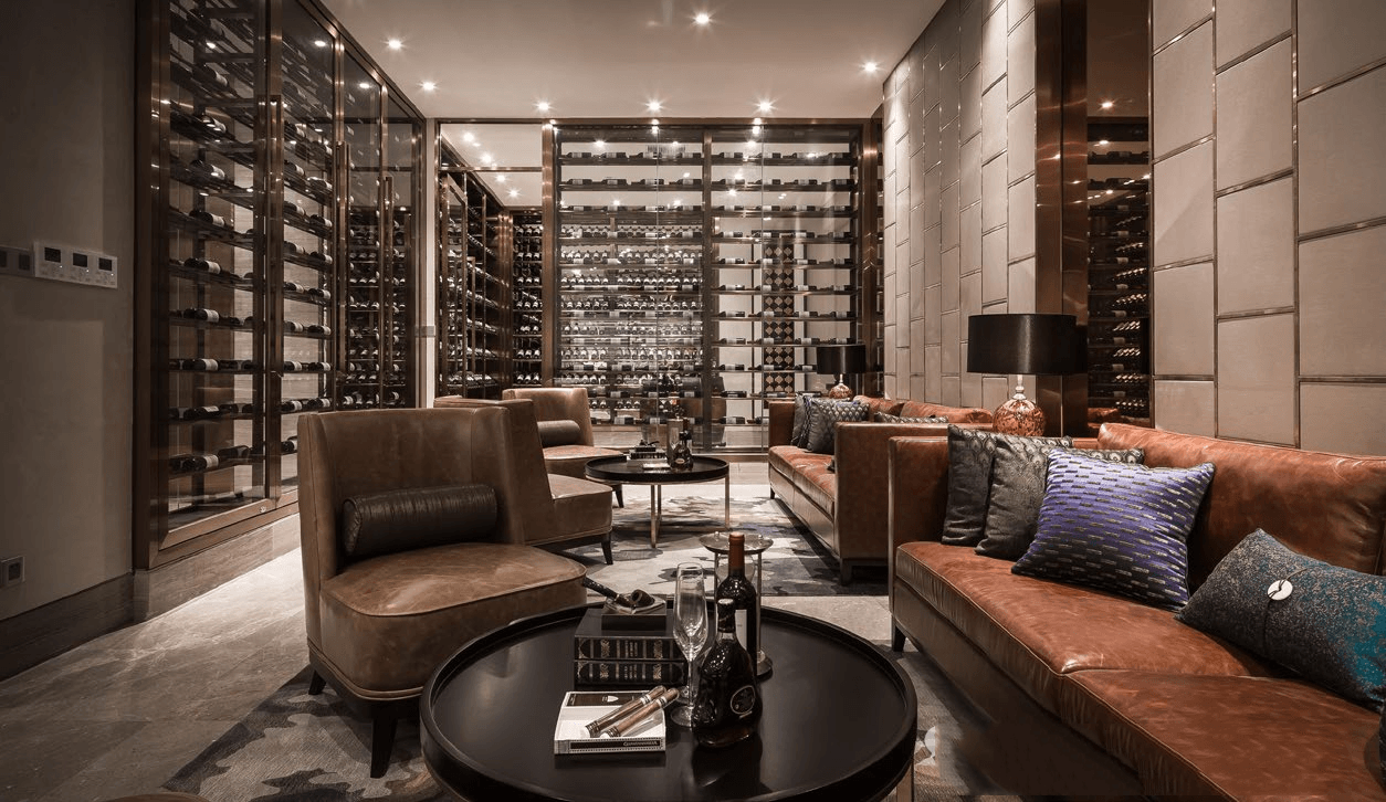 Large-scale custom stainless steel wine cabinet system in a PVD bronze finish for private wine cellars and luxury hospitality venues.