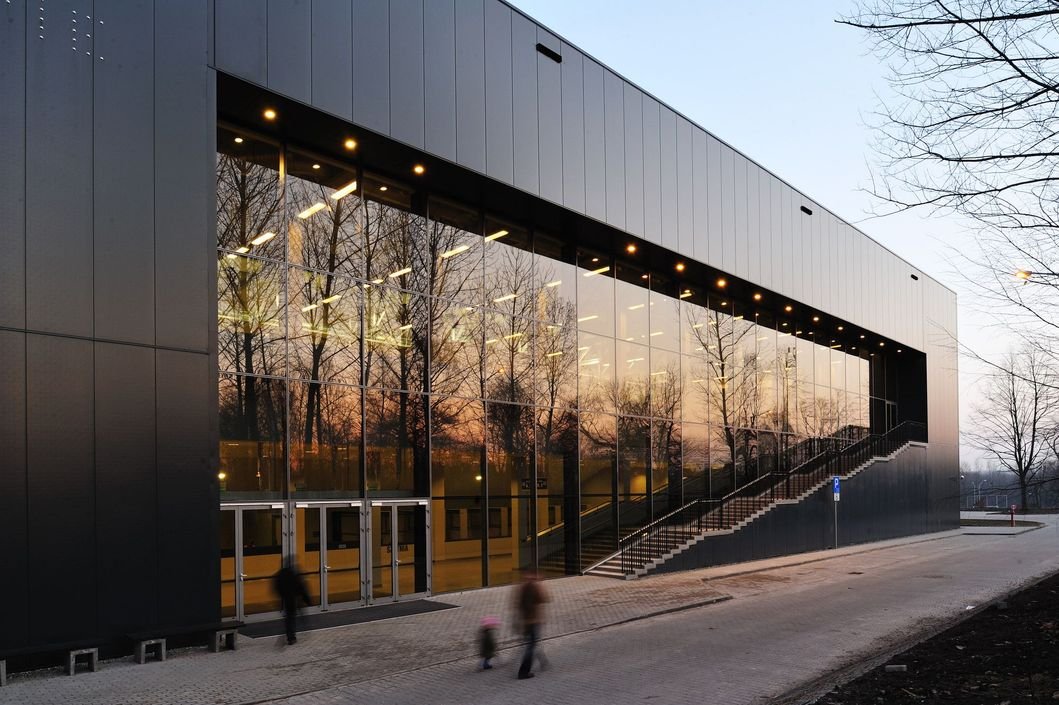 Sleek dark grey unitized Architectural Aluminium Cladding for a modern sports facility or commercial building.