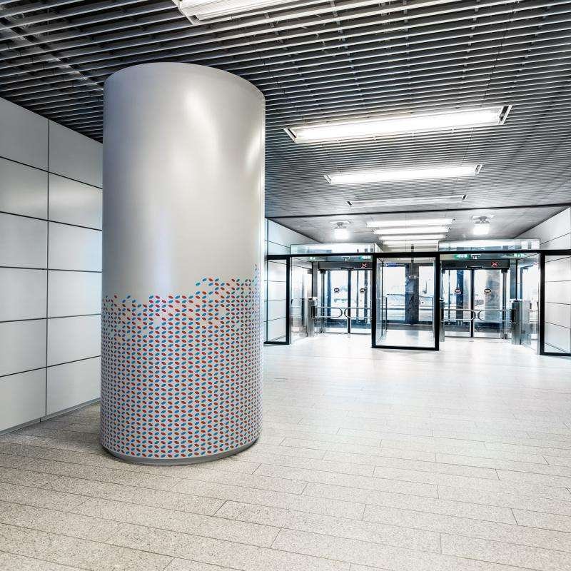 Stainless Steel Column Covers with custom decorative patterns for shopping mall interior design and structural protection