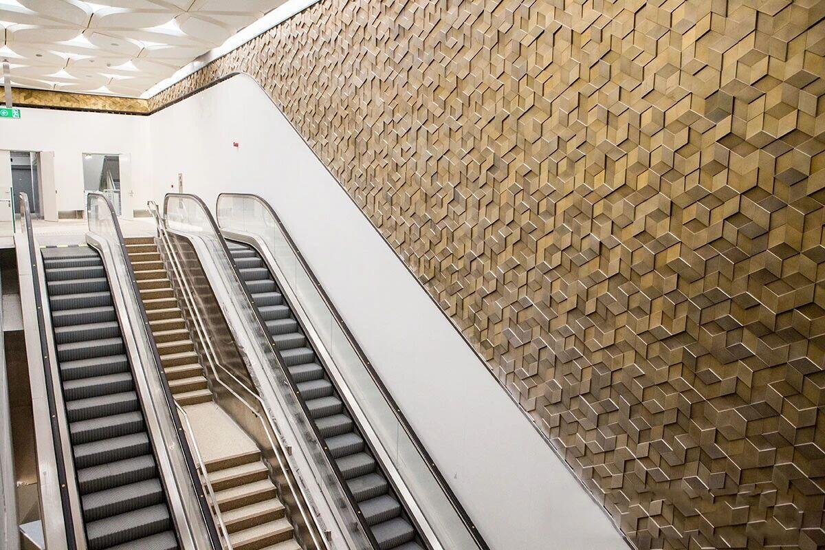 doha-metro-escalator-slope-wall-bronze-3d-tessellated-panels
