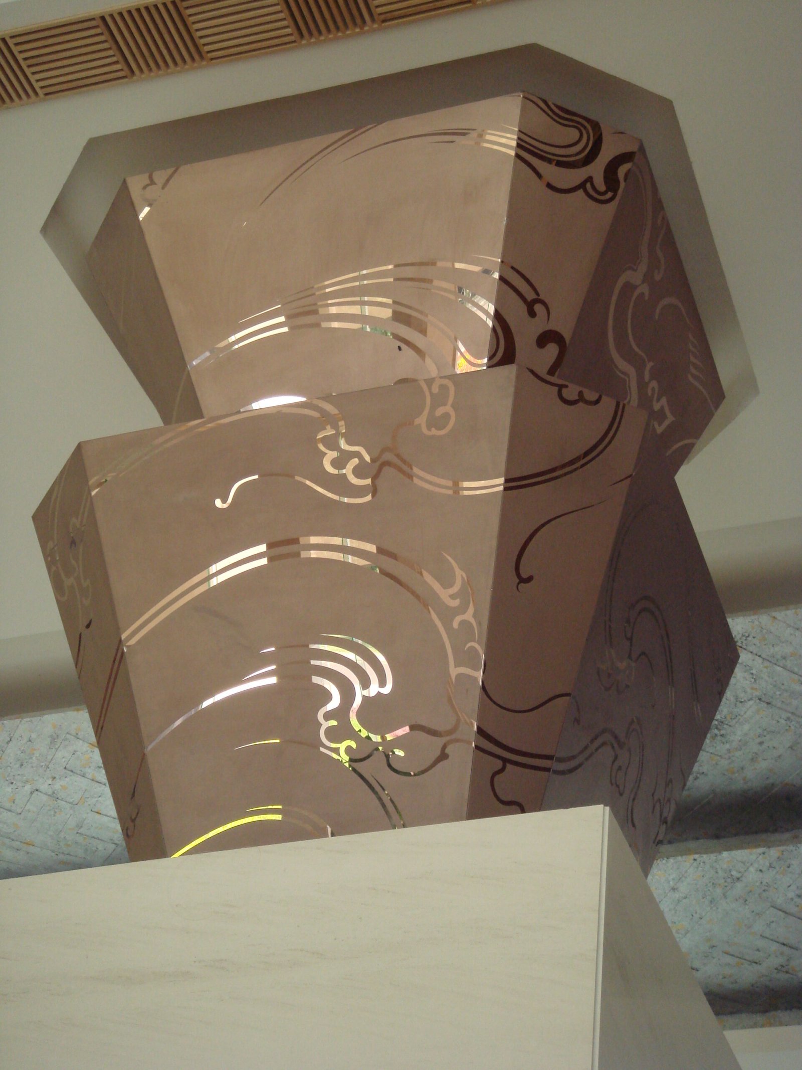 Custom etched stainless steel sheets used as architectural column fascia panels in upscale interior projects