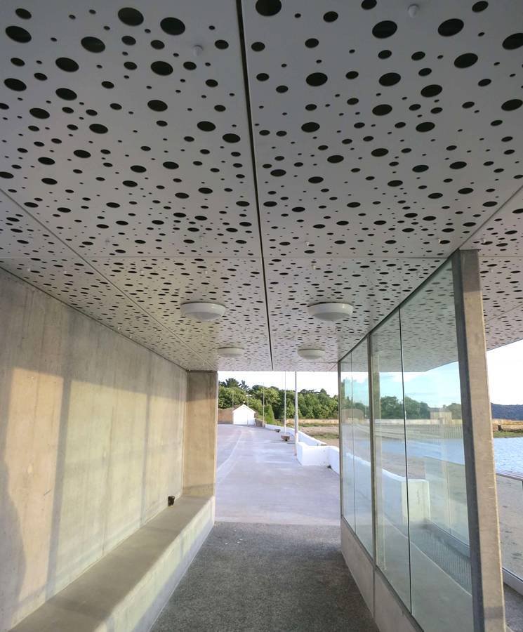 Architectural Metal Ceiling Systems and exterior metal canopies featuring precision perforated patterns for modern facades