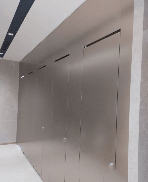 Premium floor-to-ceiling brushed stainless steel toilet partitions doors for a durable and hygienic commercial restroom.