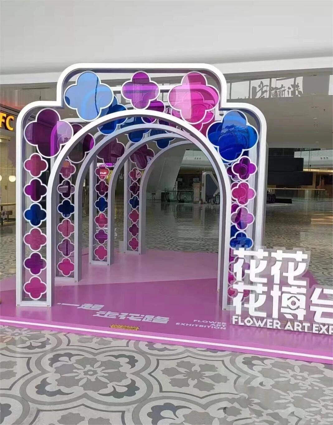 Decorative custom-fabricated metal arches with vibrant panels for architectural art exhibition by XYC Metalworks.