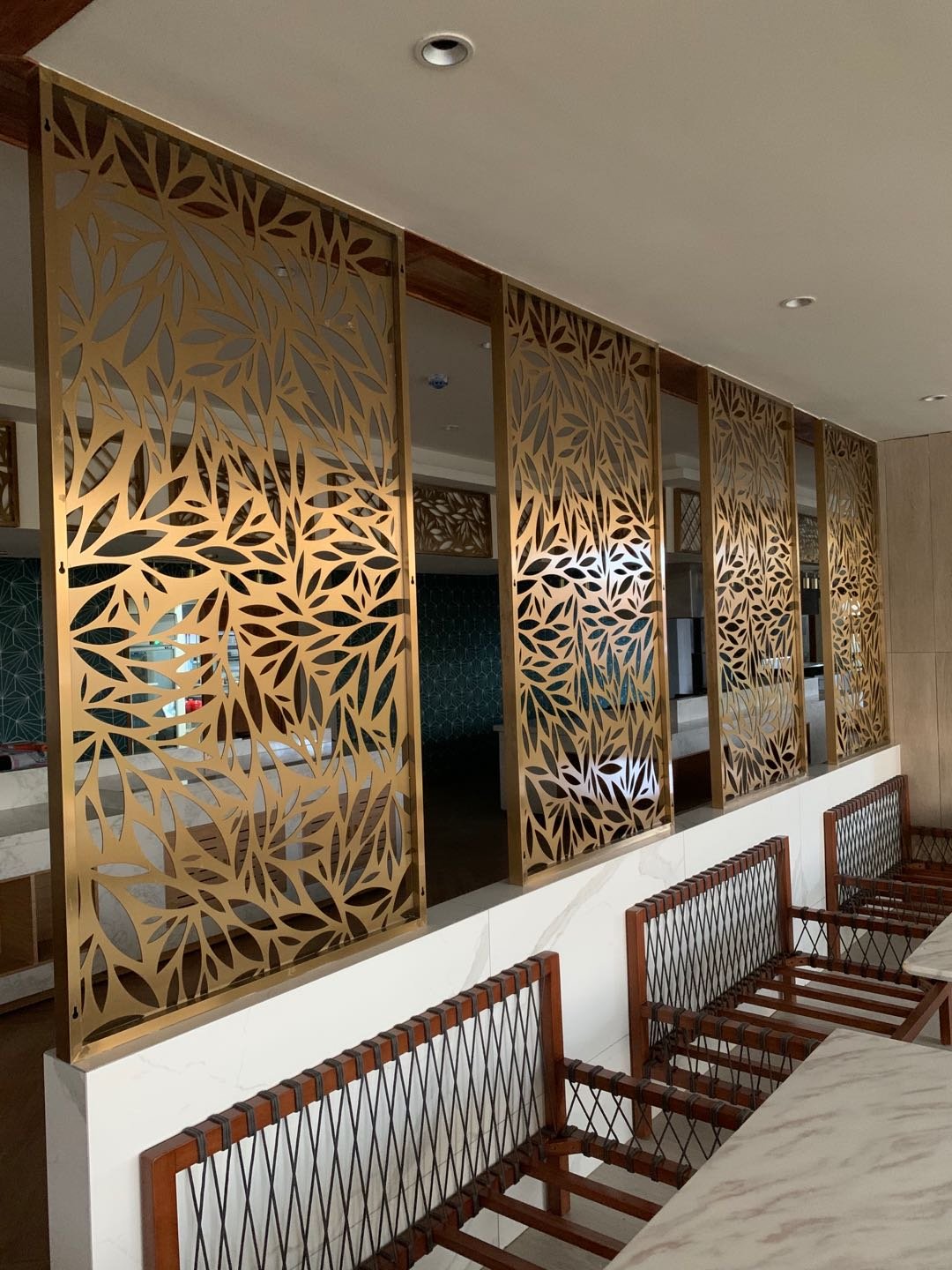 Premium gold PVD coated laser-cut stainless steel sheets featuring an organic leaf pattern for decorative restaurant wall panels and screens.