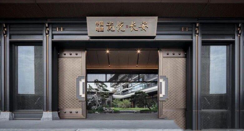 Grand New Chinese-Style courtyard entrance gate custom-fabricated from PVD bronze stainless steel with traditional rivet details for the Longyue Chang'an luxury residential project by XYC Metalworks.