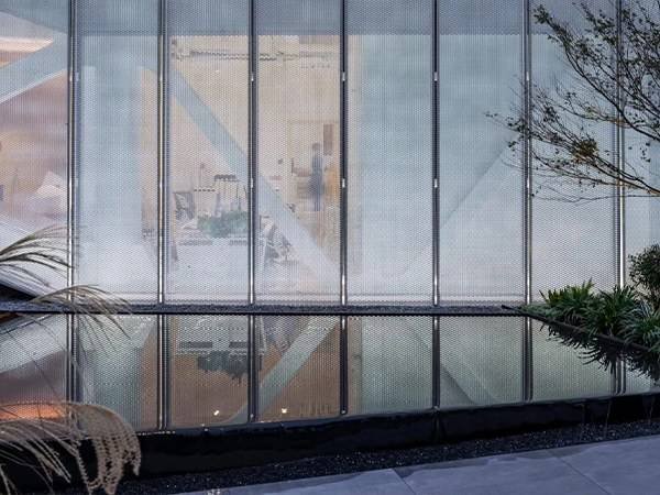 Heavy-duty stainless steel expanded metal mesh used as a secure partition and barrier for industrial or commercial sites.