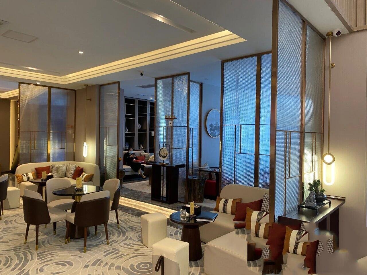 Architectural Metal Partitions and sliding privacy screens for luxury hotel lounge areas featuring integrated metalwork patterns