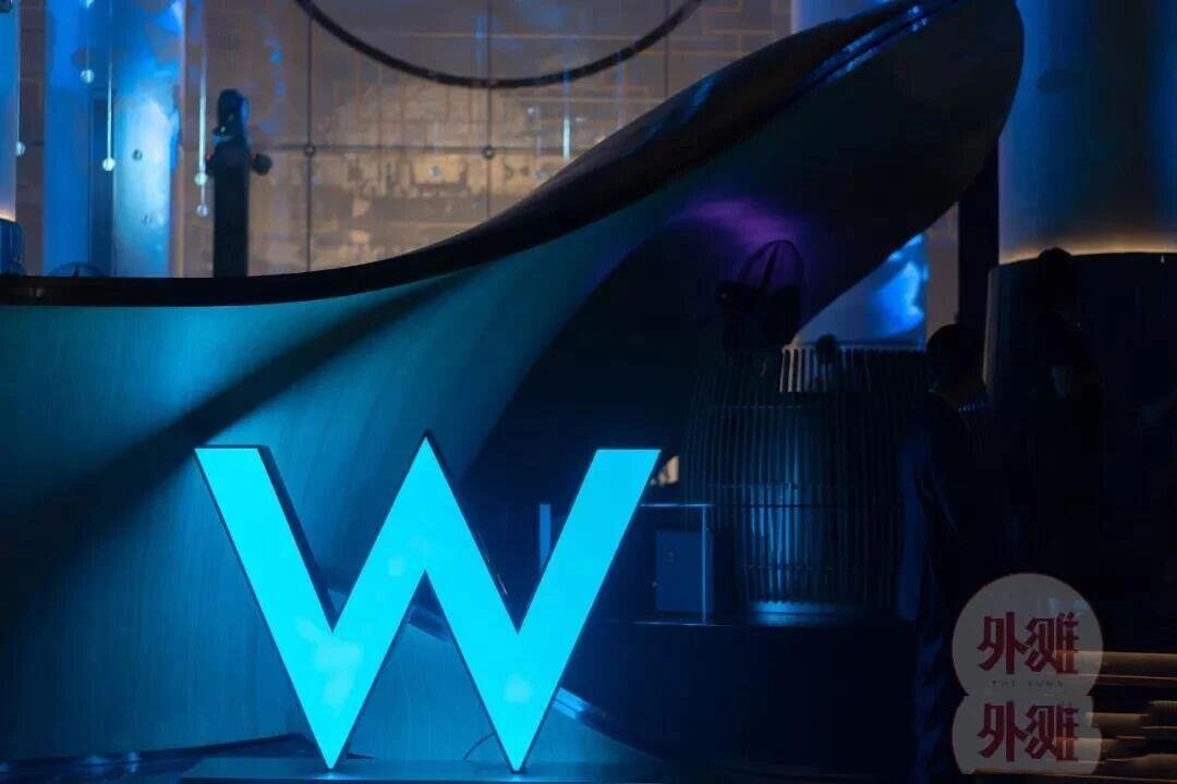 Large-scale 3D fabricated letters with blue face-lit LED illumination for modern hospitality architectural signage.