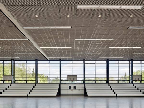 Vertical interior partition using expanded metal mesh screens to enhance privacy while maintaining ventilation and natural light.