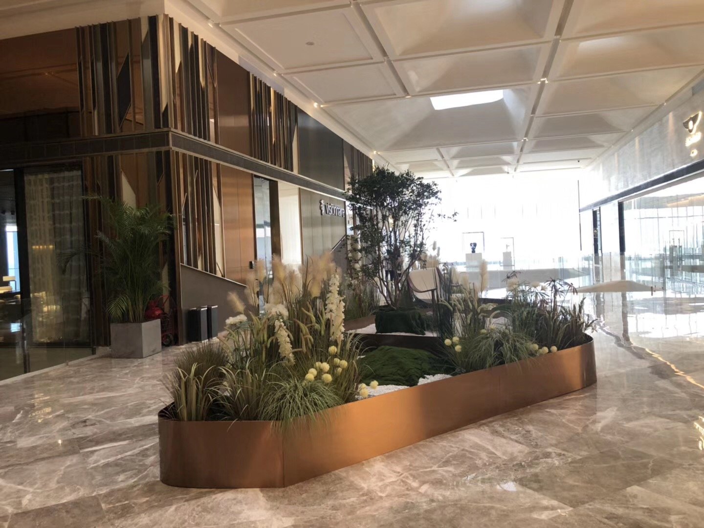 large-curved-bronze-metal-planter-commercial-lobby