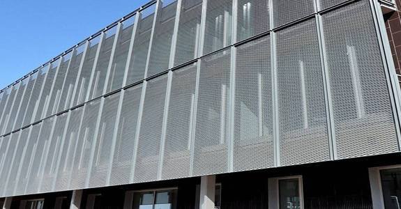 arge-scale expanded metal mesh facade system for passive ventilation, light diffusion, and building sunshades.