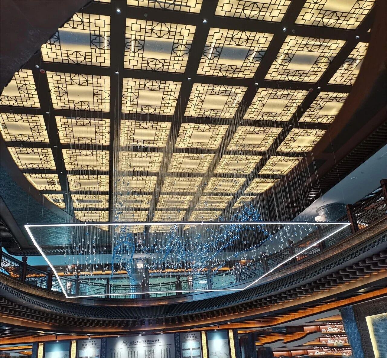 Architectural Metal Ceiling Systems featuring an illuminated lattice grid design for high-end luxury hospitality interiors
