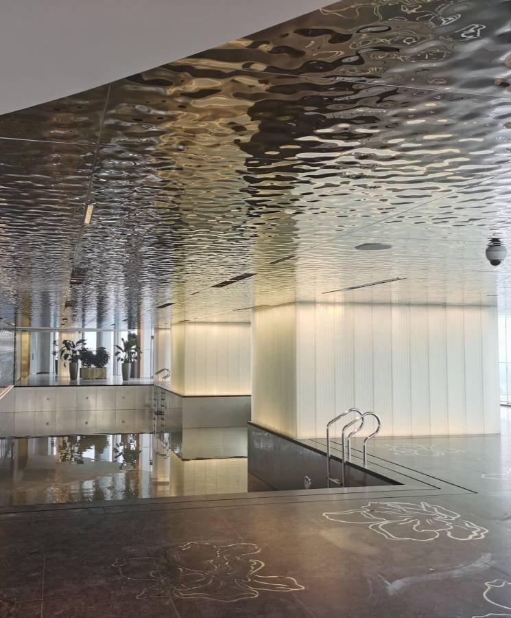 Architectural Metal Ceiling Systems using 3D water ripple mirror-polished stainless steel sheets for luxury pool interiors