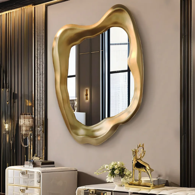 Sculptural PVD gold wavy mirror frame, designed to pair with Custom Stainless Steel Vanity Stands as a highlight of our Bespoke Metal Mirror Frames and Luxury Hospitality Washroom Metalwork.