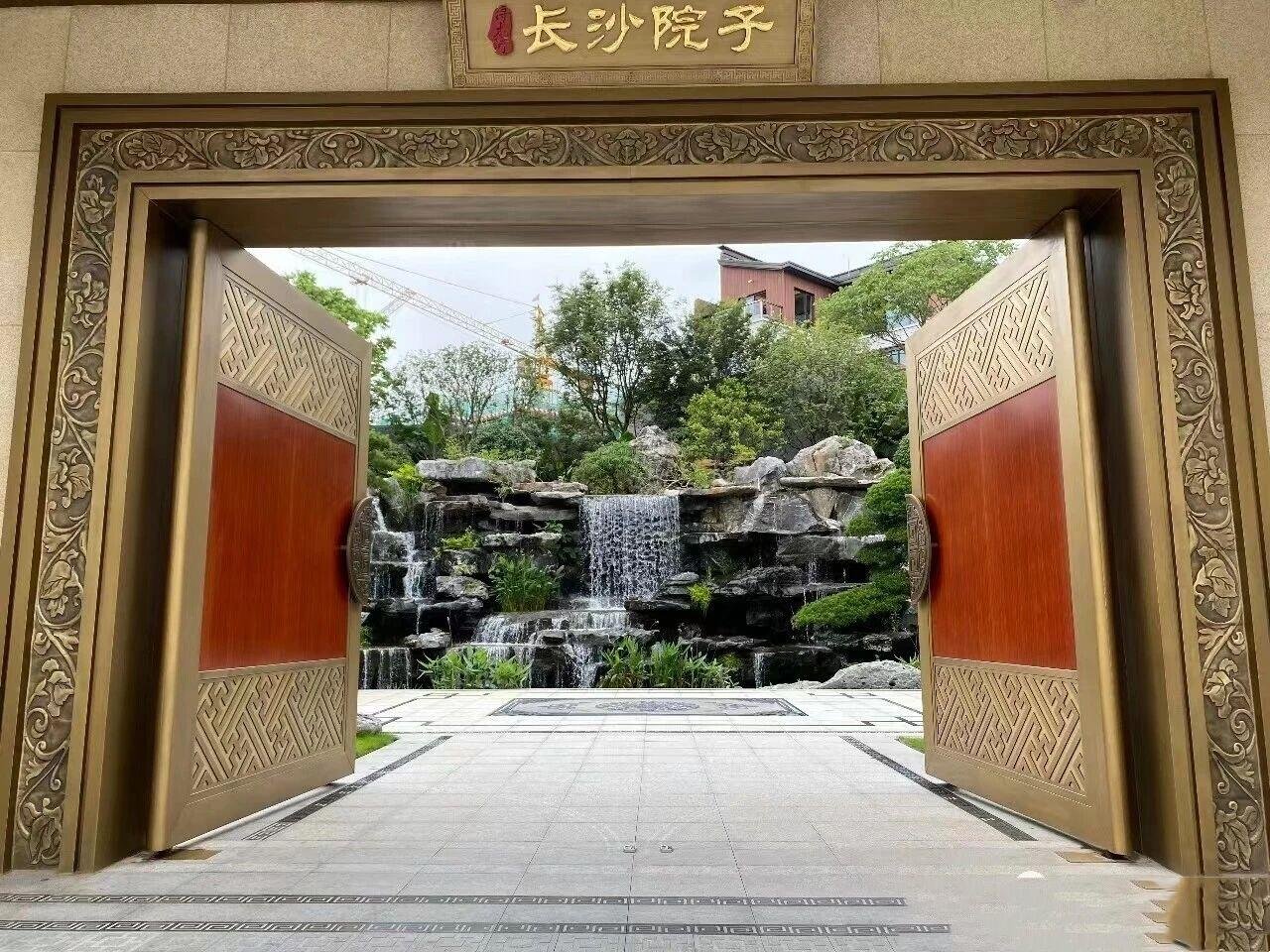 A large ornate bronze stainless steel door with metal handles