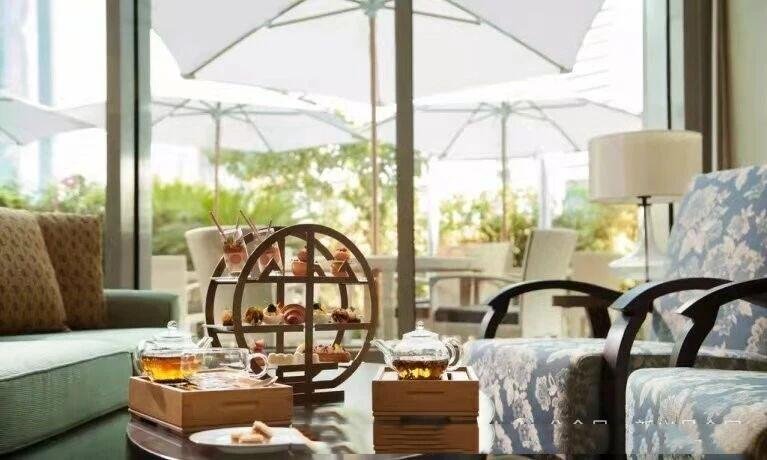 Bespoke oriental-style circular metal afternoon tea display rack for luxury hotel lounge service featuring a tiered decorative design.