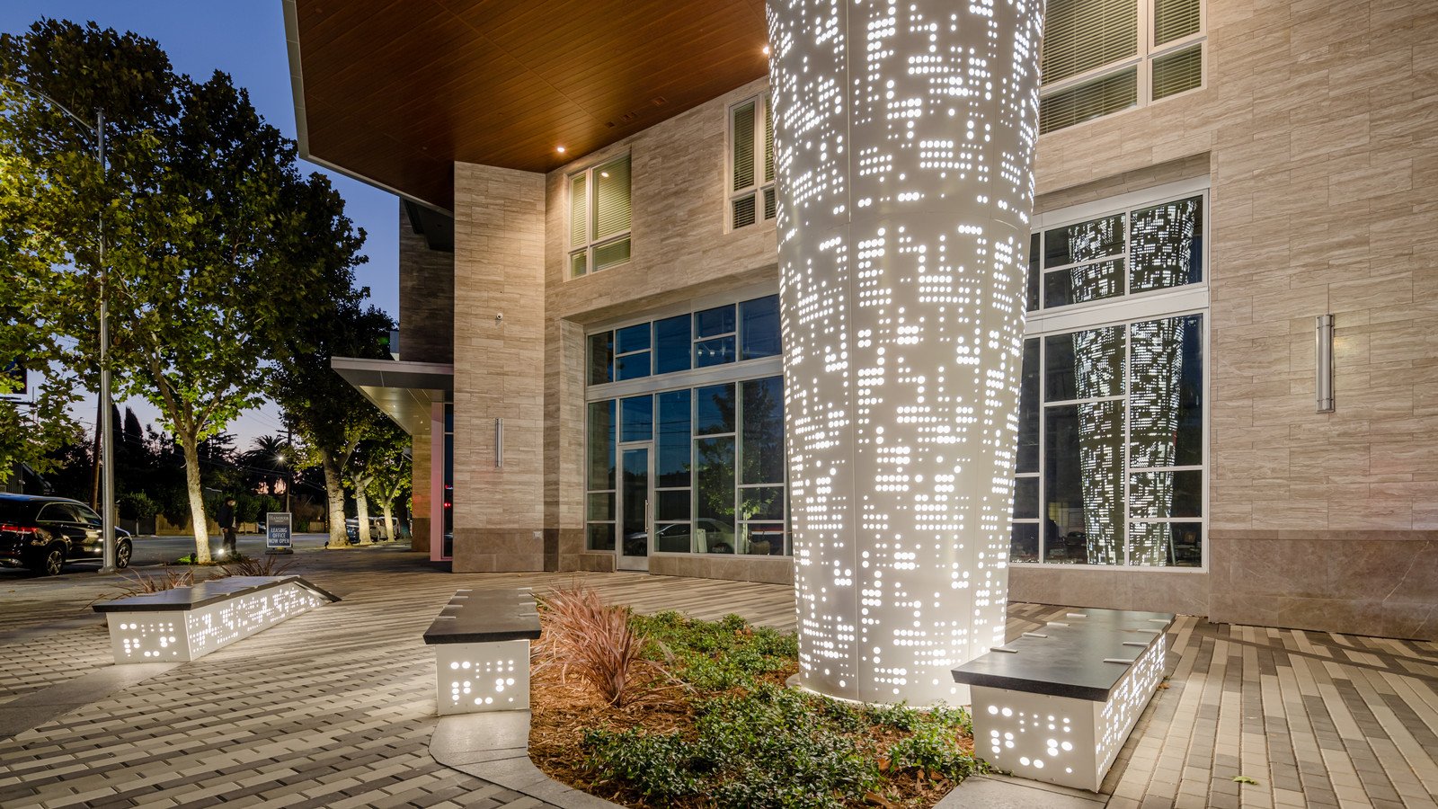 Stainless Steel Column Covers featuring perforated metal patterns and integrated LED lighting for modern urban plazas