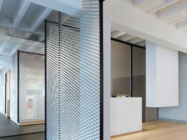 White powder-coated aluminum expanded metal mesh interior partition screens for modern office design and functional privacy.