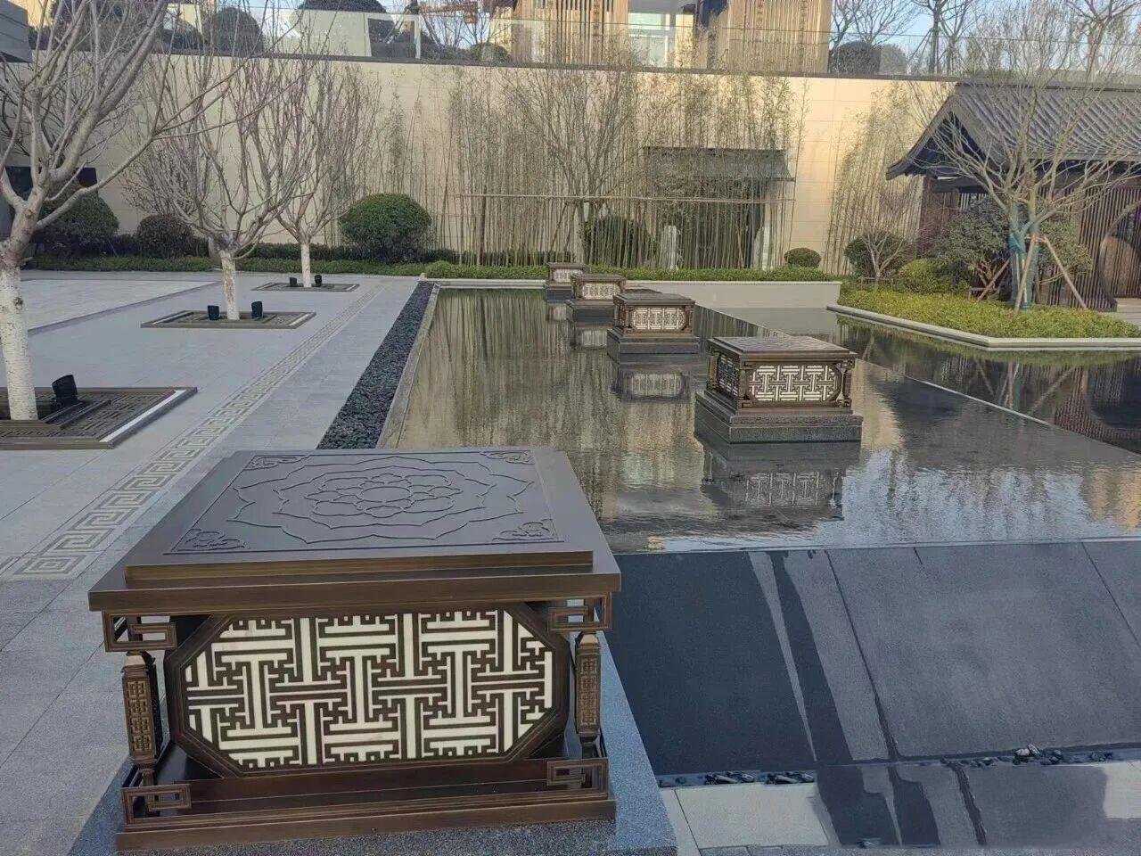 Custom landscape metal features featuring PVD bronze Chinese-style stainless steel lanterns and bollards for exterior lighting.Custom landscape metal features featuring PVD bronze Chinese-style stainless steel lanterns and bollards for exterior lighting.
