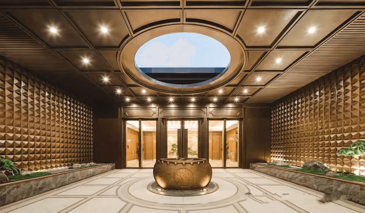 PVD Coated Stainless Steel pyramid-textured 3D wall panels creating a stunning metallic luster in a hotel entrance.