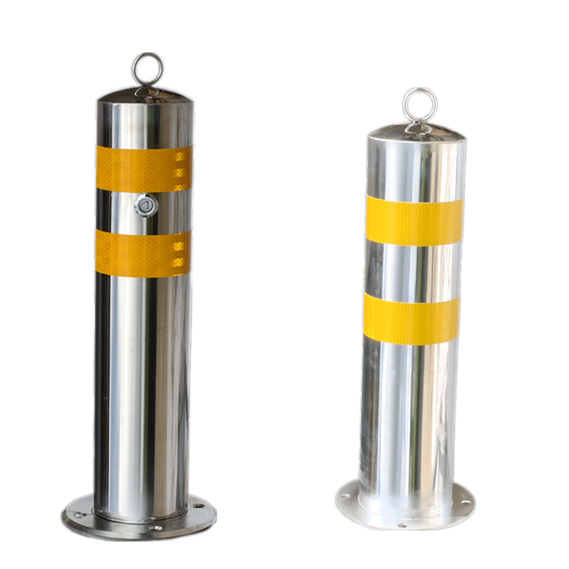 Two surface-mounted removable stainless steel bollards, showing the key-lock mechanism and yellow reflective tape