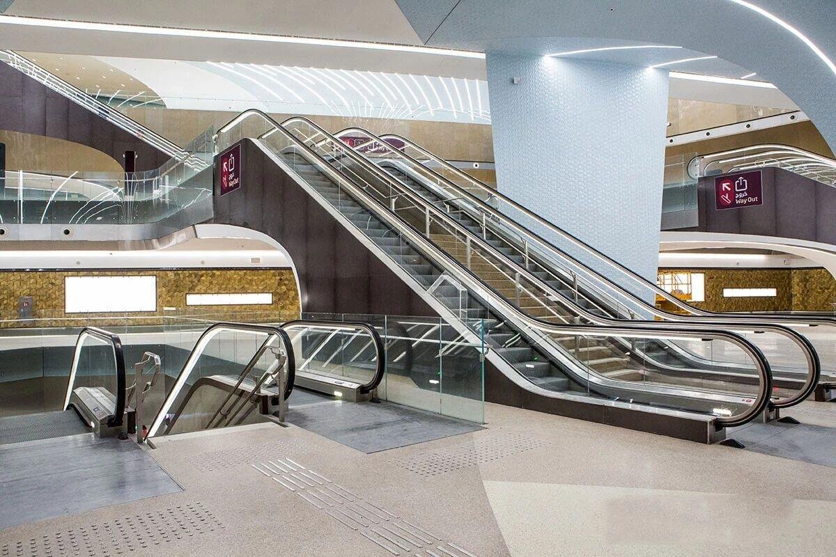 Escalator Wall Cladding and stainless steel panels with a rose gold sandblasted finish for high traffic transit station halls