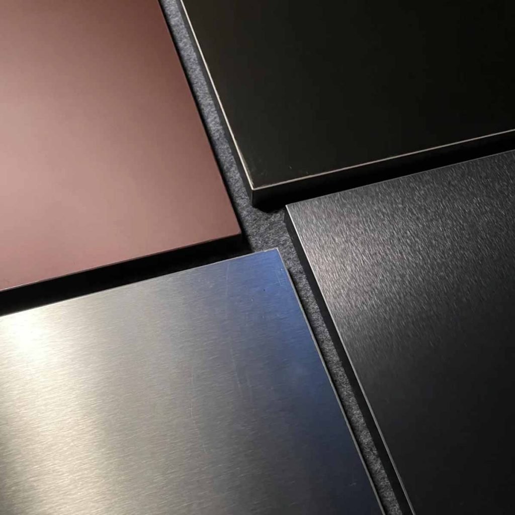 Satin finish stainless steel sheets custom samples in copper, black, and silver, showcasing exceptional wear and scratch resistance.