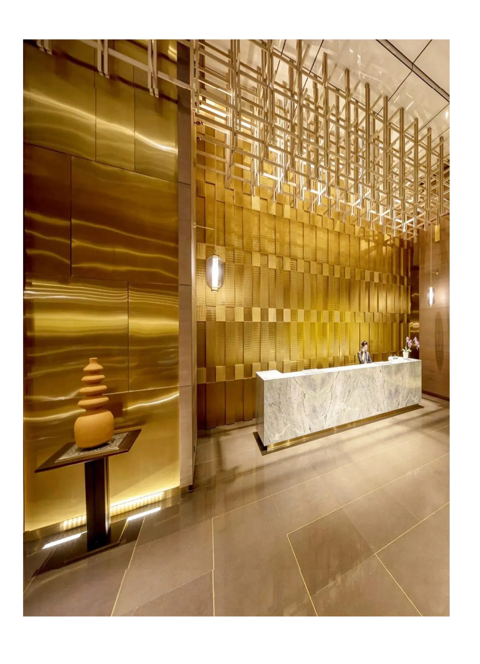 Satin finish stainless steel sheets in titanium gold used for luxury hotel lobby wall cladding to create a stunning modern atmosphere.
